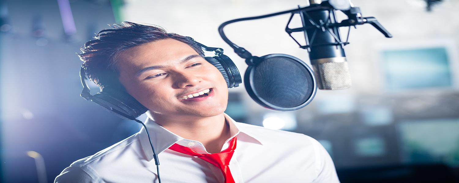 Asian professional musician recording new song or album CD in studio